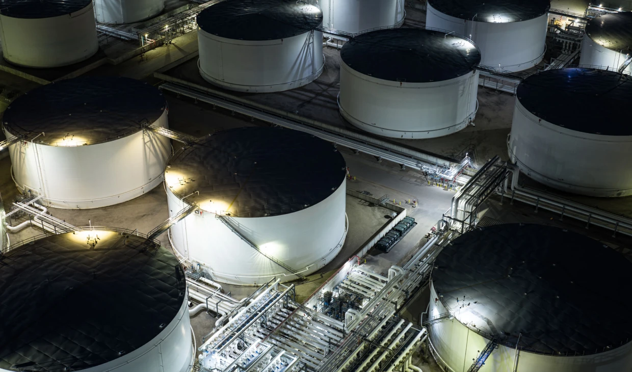 Industrial tanks illuminated at night
